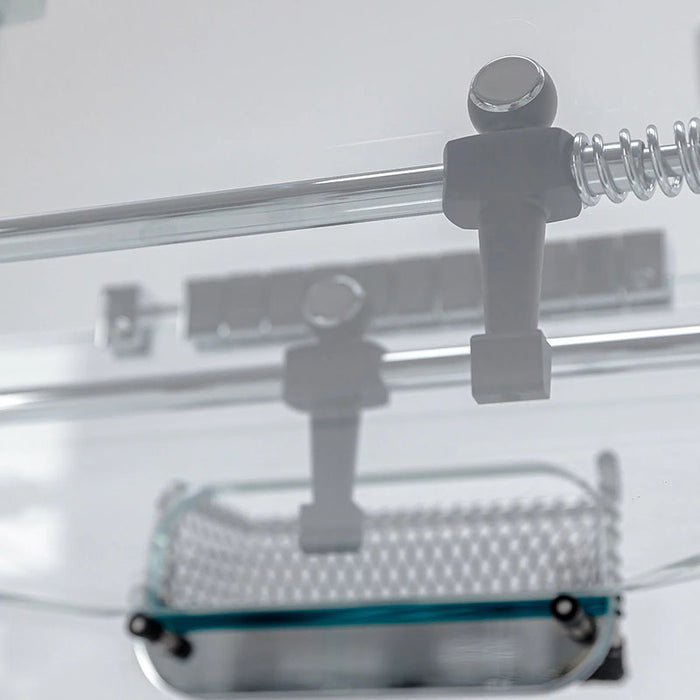 Close-up of the glass playing field and net on the Teckell Cristallino Classic Foosball Table.