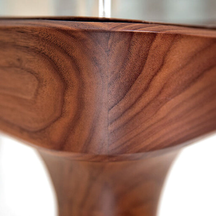 A close-up of the corner of the Teckell Intervallo Foosball Coffee Table, highlighting the smooth Canaletto walnut finish and glass detailing.