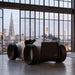 Teckell Nivola Racing Simulator positioned in a luxury apartment overlooking a city skyline during daylight.