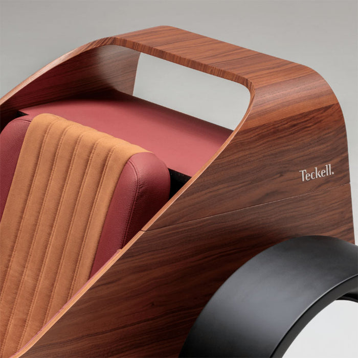 Close-up of the Teckell Nivola Racing Simulator featuring handcrafted walnut bodywork and premium upholstered racing seat.
