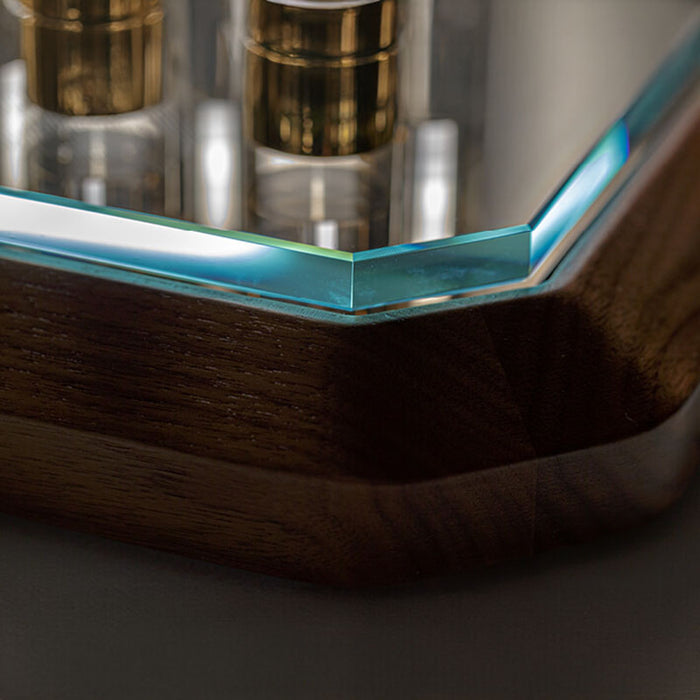 A close-up of the game board’s corner, showing the seamless integration of the low iron tempered glass top with the elegant Canaletto walnut wood base.