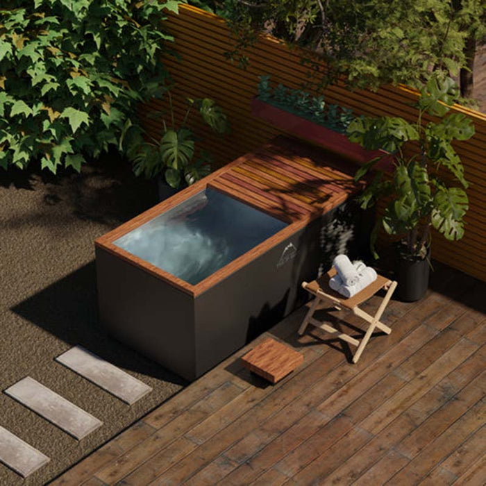 he Three Degree Club Rocky Ice Bath in an outdoor garden, blending seamlessly with nature, offering the perfect ice bath or hot tub experience.