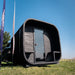 Front view of the Ula Grand 6-Person Outdoor Sauna in Ebony finish with covered porch and glass door.