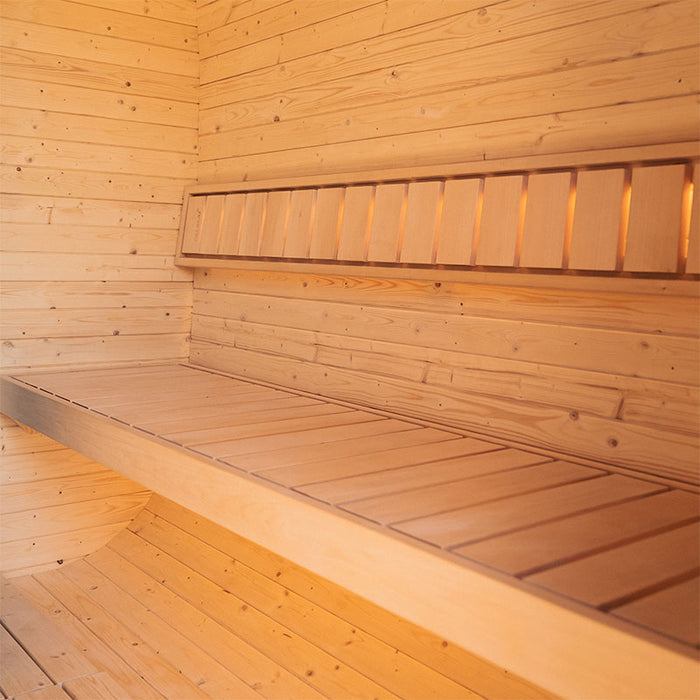 Wide interior view of the Ula Grand 6-person outdoor sauna showing wooden bench seating and ambient wall lighting.