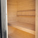 Interior bench seating seen through the glass door of the Ula Grand 6-person outdoor sauna.