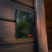 Harvia digital control panel mounted on the exterior wall of the Ula Mini 2-person sauna for precise temperature regulation.
