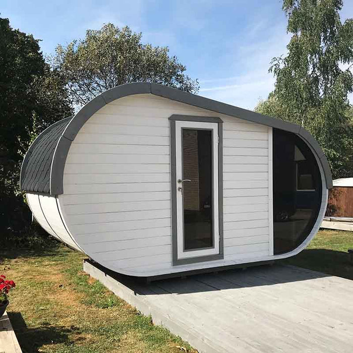 Front view of Delight Outdoor Sauna in garden.