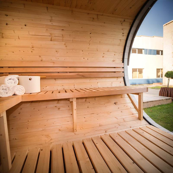 Wooden interior of Viking Industrier Delight Sauna 2.4 x 4.3m showing large glass window, benches, bucket and towels. 