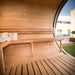 Wooden interior of Viking Industrier Delight Sauna 2.4 x 4.3m showing large glass window, benches, bucket and towels. 