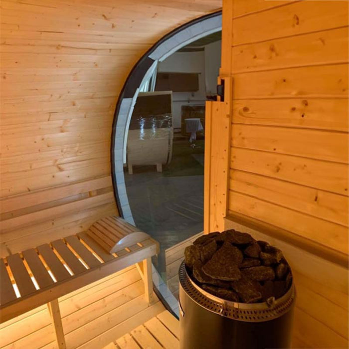 Interior view of glass window, wooden benches and Harvia Heater in Delight Sauna 2.4 x 4.3m.