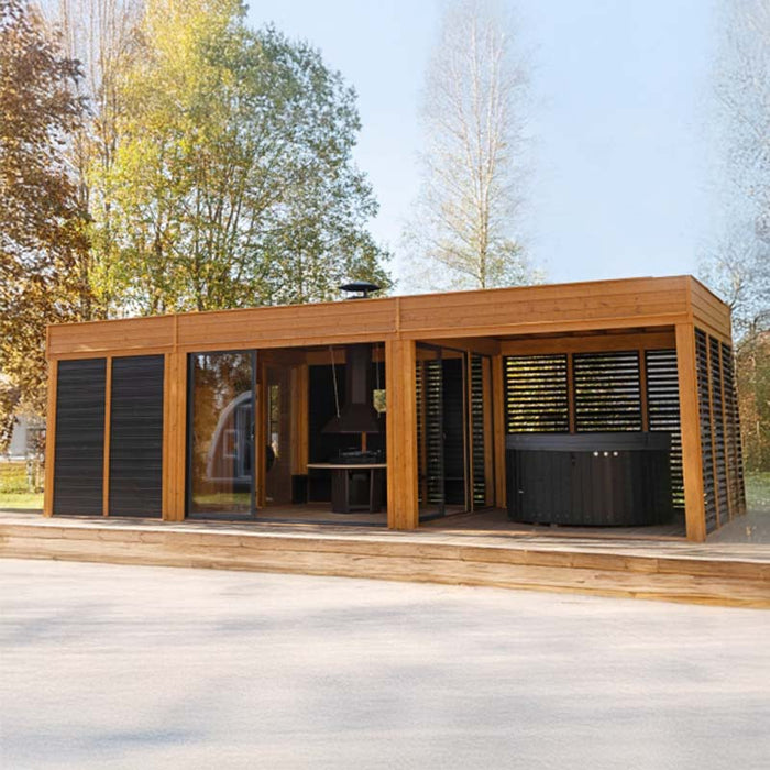 A stunning Garden Cube 3 x 8m showcasing a luxurious blend of a sauna, barbecue area, and lounge, framed in premium spruce wood.