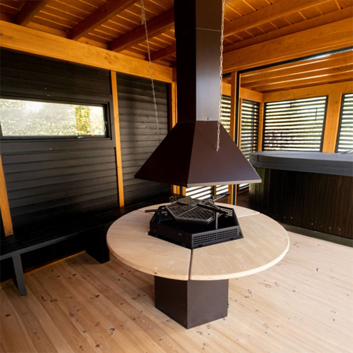 Focused shot of the integrated barbecue grill with a surrounding table and chimney for seamless outdoor cooking.