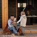 A father engaging his kids in a story while sitting on the deck of the Garden Cube, highlighting its inviting atmosphere.