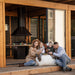 A family lounging and enjoying quality time outside the Garden Cube, highlighting its role as a perfect spot for relaxation and togetherness.