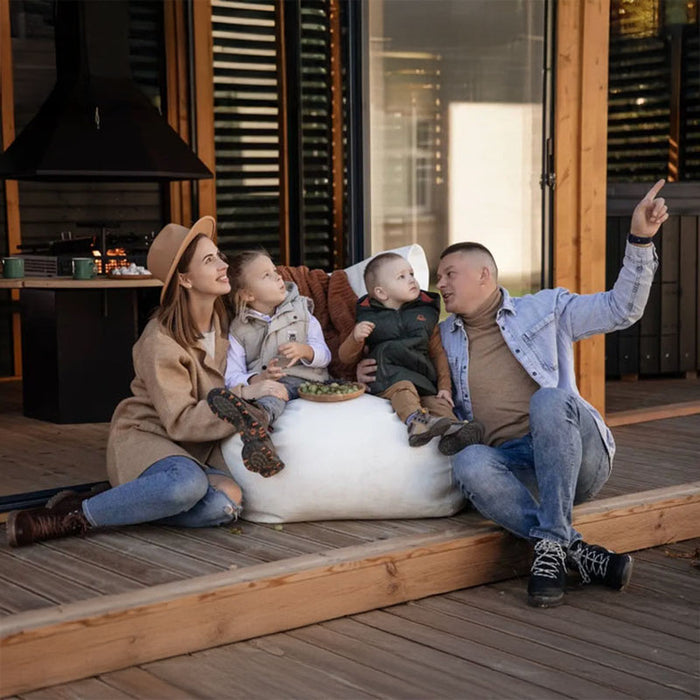 A candid lifestyle shot of a family experiencing the comfort and warmth of the Garden Cube’s combined sauna and lounge area.