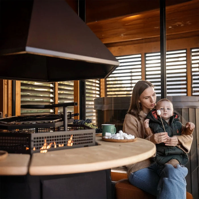 A heartwarming moment of a mother holding her child near the lounge area, illustrating the family-friendly design of the Garden Cube.