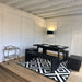 Dining area inside the Glamping Cube 3 x 7m, featuring a stylish table and benches, perfect for enjoying meals in a cosy, nature-inspired setting.