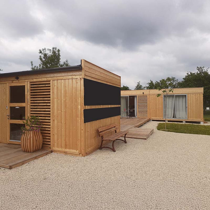 Angled daytime view of the Glamping Cube 51m² U-Shape with open outdoor space and functional layout.