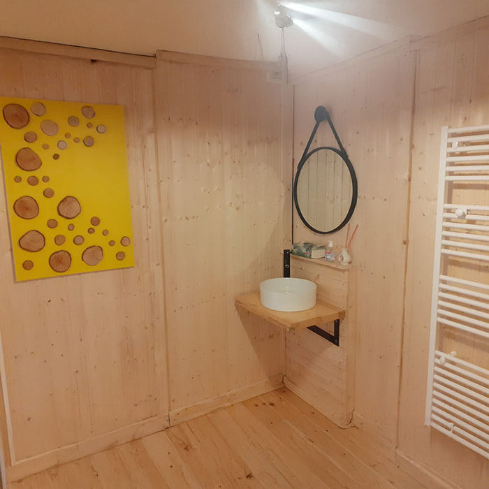 Modern bathroom side view in the Glamping Cube 51m² U-Shape with wooden walls and stylish fixtures.