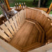 The inside of a 1.9m thermowood hot tub with comfortable bench seating and a modern chimney.