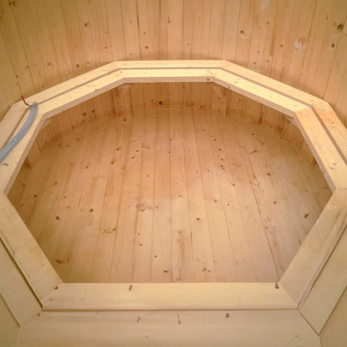 Wooden steps leading up to a hot tub on a wooden deck.