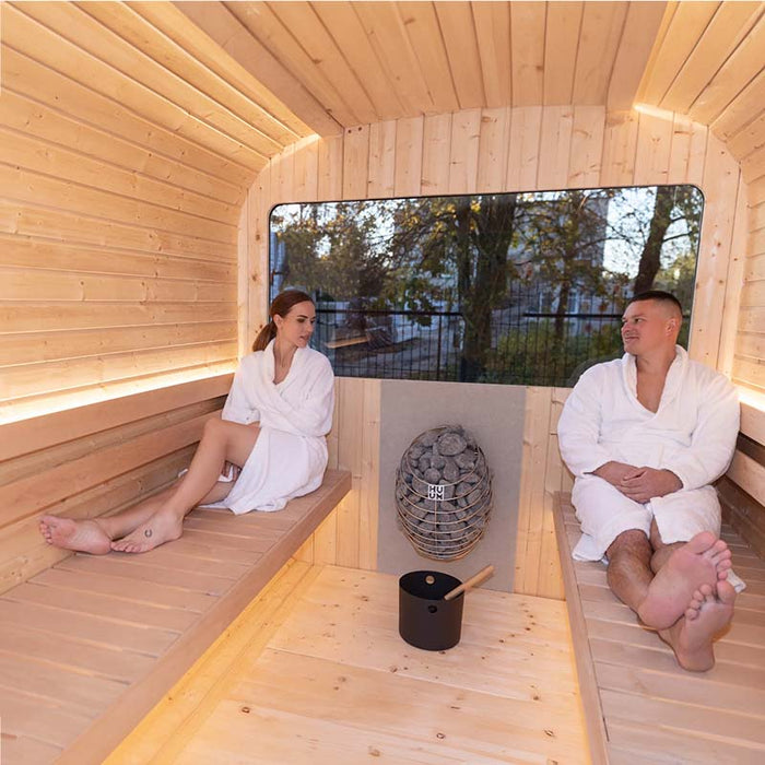 Couple sitting on wooden sauna benches in Luna Sauna 2.3 x 2.4m.