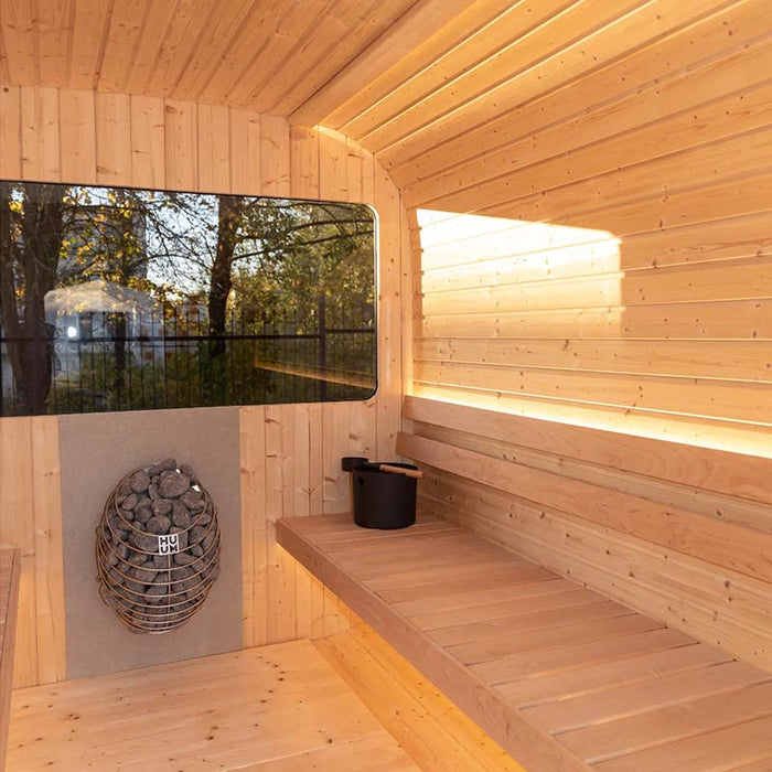 Inside view of Luna Outdoor Sauna 2.3 x 2.4m with HUUM heater, bucket and ladle.  