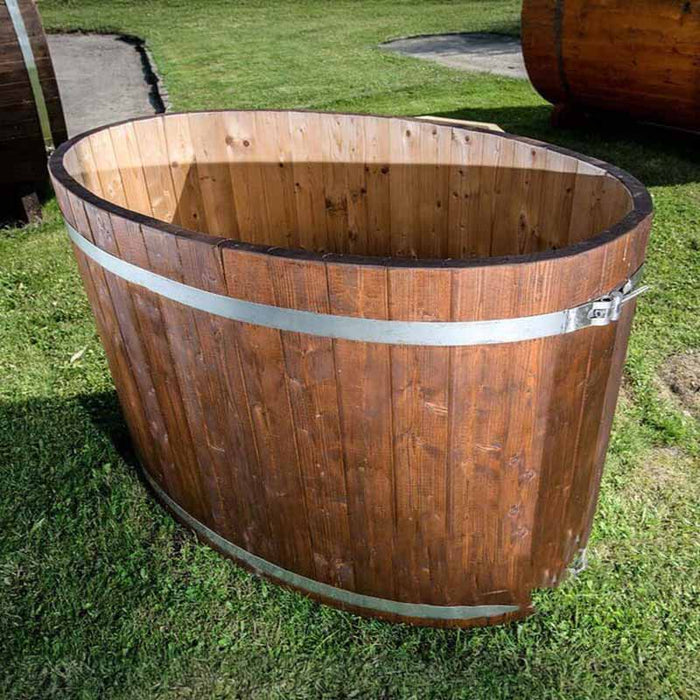 Oval cold tub made from spruce, placed on the grass.