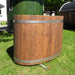 Oval cold tub made from spruce displayed on green surface.