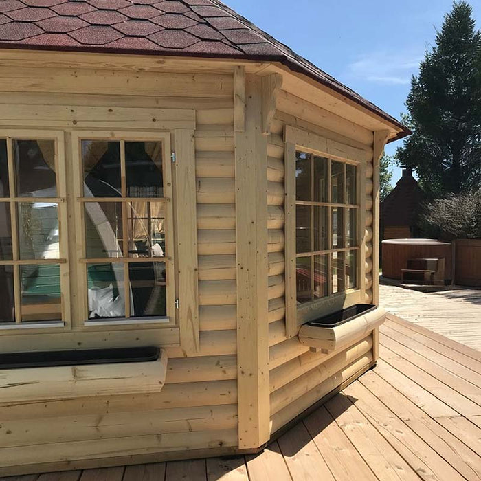 Close-up of the Pavilion 14.9m² exterior, featuring natural wood walls, large double-glazed windows, and a red shingle roof.