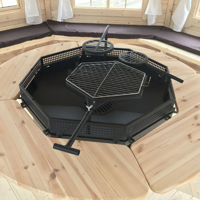 Close-up of the central grill in the Pavilion 14.9m², featuring adjustable platforms for versatile cooking.