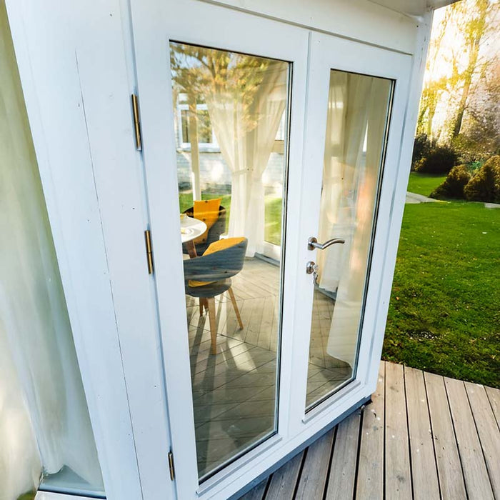 Octagonal Pavilion with Large Windows 10m² featuring seven floor-to-ceiling glass panels, a black shingle roof, and a spacious, airy design ideal for year-round entertaining and relaxation.