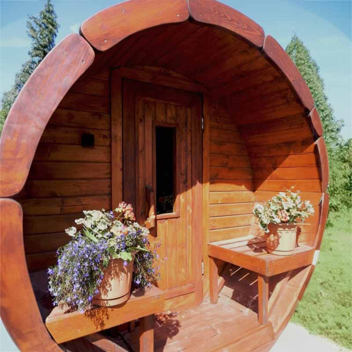 The Sauna Barrel roof is shingled and extends slightly over the entrance, providing some shelter.