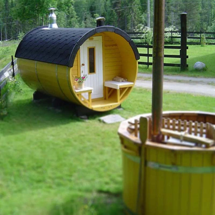 Traditional Sauna Barrel 1.9 x 3m with an open door, situated in a green grassy area with an adjacent wooden tub.