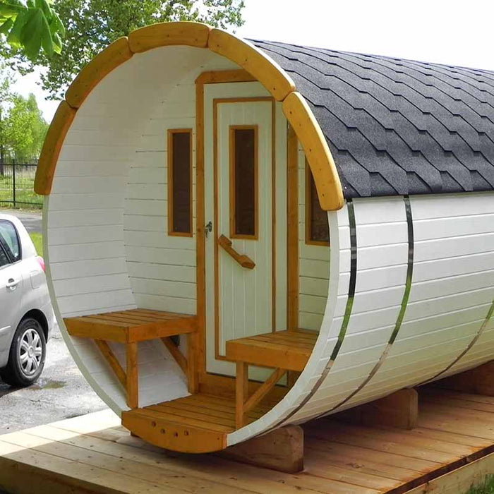 Traditional Sauna Barrel with white walls and a dark roof, featuring a front door and two exterior benches.