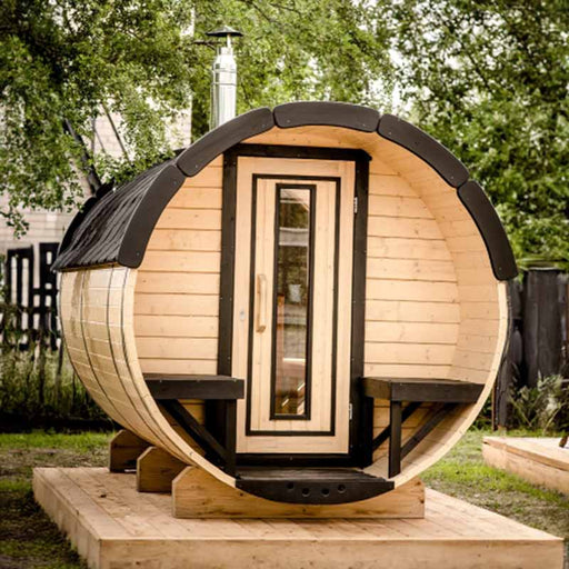 Traditional Sauna Barrel 1.9 x 3m with windows, a door, potted plants, and a bench.