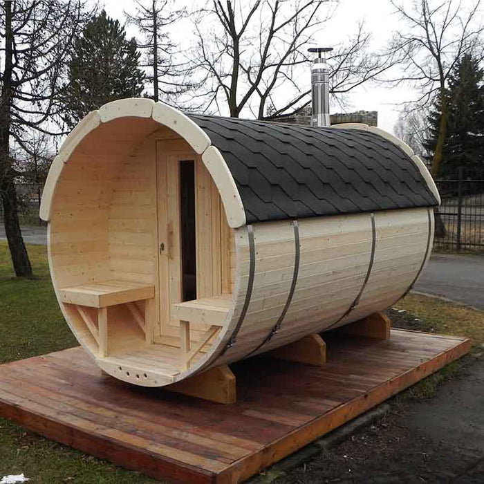 Traditional Sauna Barrel 1.9 x 3m, an outdoor wooden sauna with an open door and chimney, placed on a wooden platform.