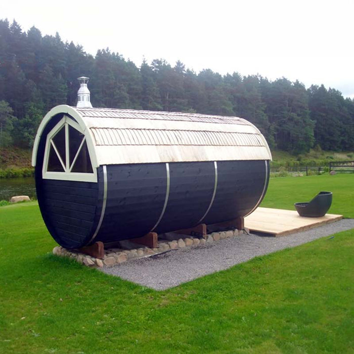 Traditional Sauna Barrel 2.2 x 4m placed on a deck with greenery in the background.