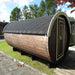 A Traditional Sauna Barrel 2.2 x 4m set outdoors on a grassy area.