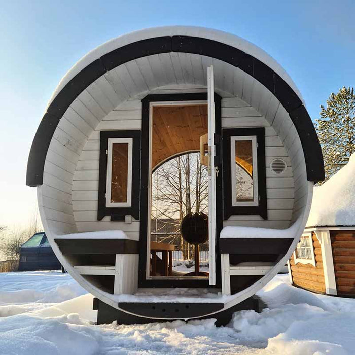 Front view of entry to Sauna Barrel with terrace and open door.