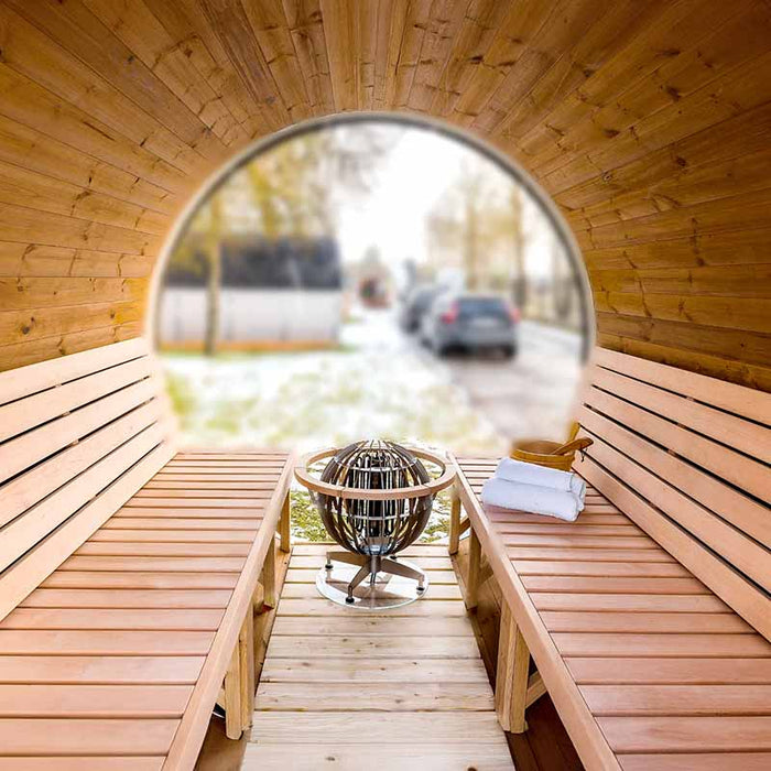 Frontal interior view of Sauna Barrel from Thermowood 2.2 x 3m with heater, bucket and towel.