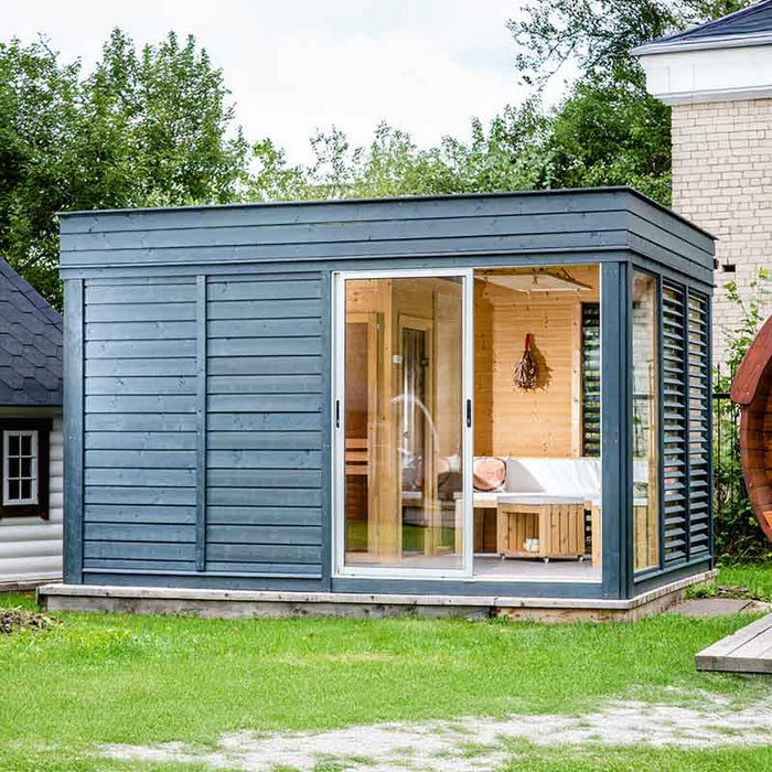 Front view of Viking Industrier Sauna Cube 3 x 4m with open sliding door and wooden interior in a garden setting. 