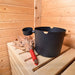 Bucket and swaddle inside of Traditional Sauna Cube 3 x 4m with Lounge.