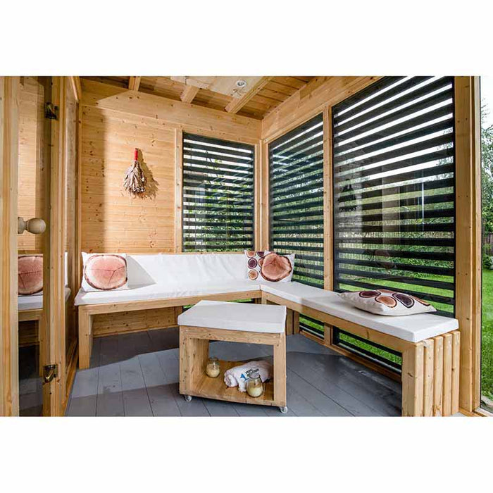 Interior view of Viking Industrier Sauna Cube with wooden benches and windows.