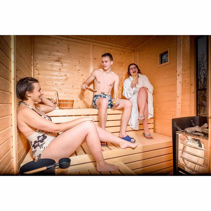 Traditional Sauna Cube 3 x 4m with Lounge with smiling people.