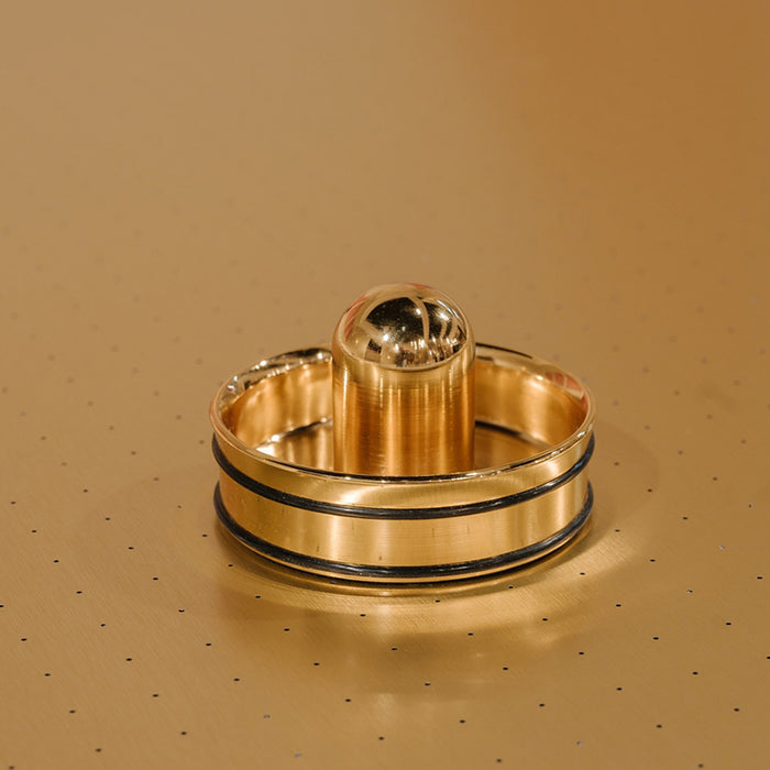Close-up of gold-plated air hockey striker on Vismara Arya table – detailed view of luxury game table accessory.