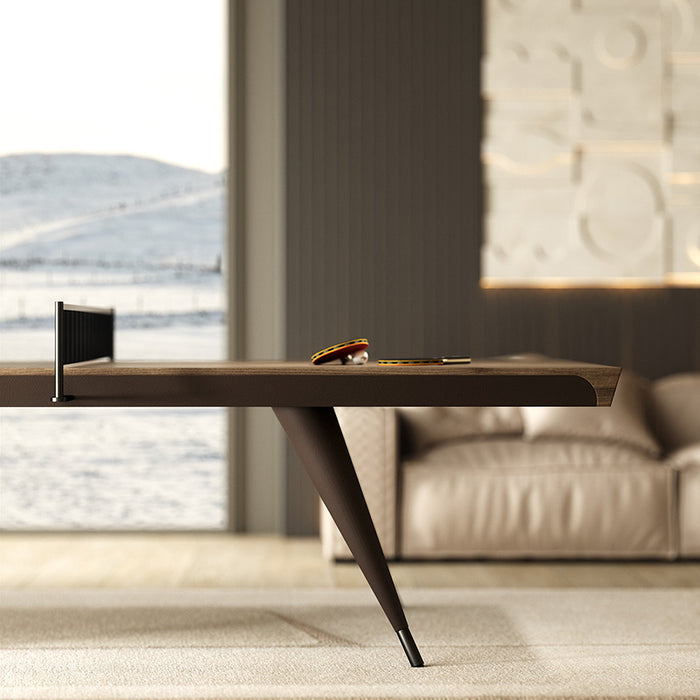 The Vismara Blade Table Tennis Table in a stylish living room, featuring its luxurious leather-wrapped structure and wood veneer top, adding elegance to the space.