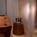 Elegant dark brown Vismara Bobo Cue Rack positioned beside a luxury pool table with wood detailing in a softly lit room.
