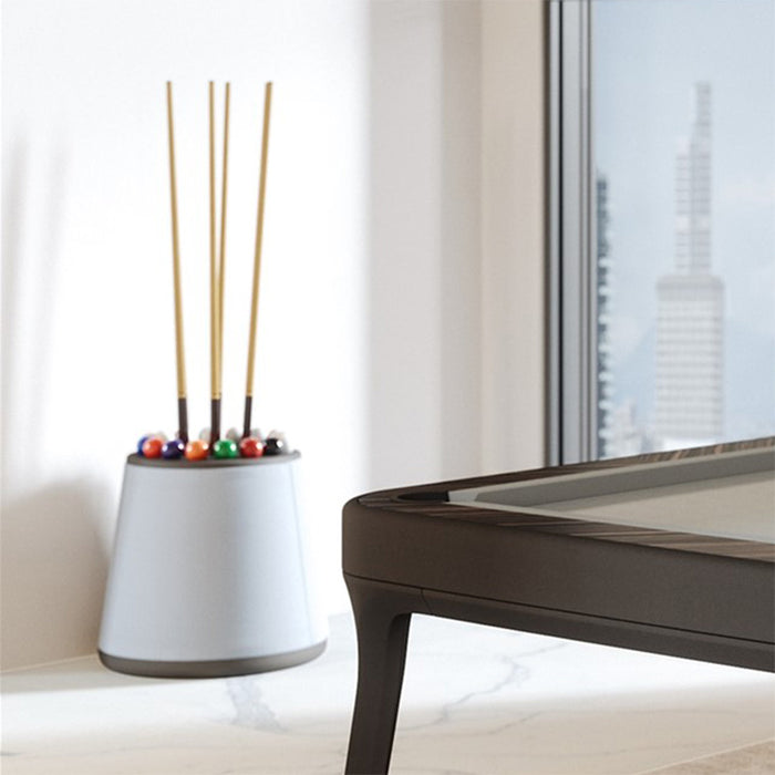 Sophisticated city apartment featuring the Vismara Bobo Cue Rack and high-end pool table beneath gold pendant lighting.