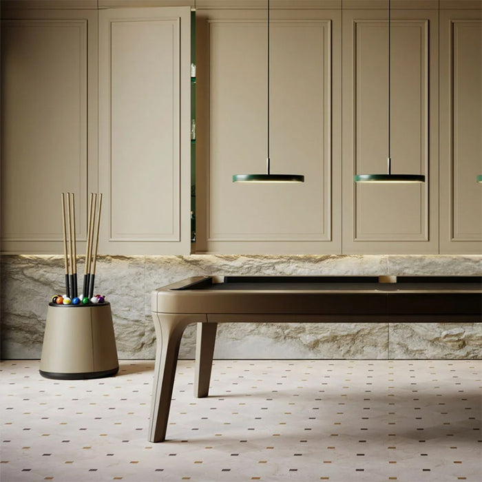 Designer billiard room featuring the Vismara Bobo Cue Rack in beige leather and matching pool table, highlighted by soft ambient lighting.